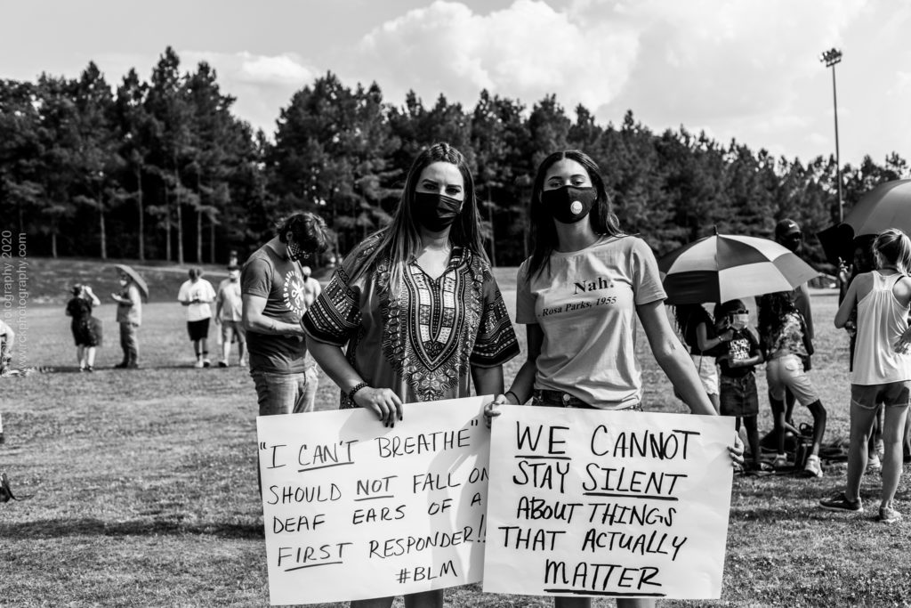 black and white image of two African American Women carrying signs during a Black Lives Matter March captured as Black History 